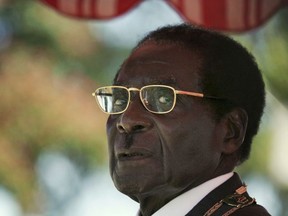 FILE - In this Friday, April, 18, 2008 file photo President Robert Mugabe waits to deliver his speech during the 28th Independence Celebrations in Harare. Zimbabwe's Parliament erupted in cheers Tuesday Nov. 21, 2017 after the speaker announced the resignation of President Robert Mugabe after 37 years in power. (AP Photo/Tsvangirayi Mukwazhi, File) ORG XMIT: TH112

Friday, April, 18, 2008 file photo
Tsvangirayi Mukwazhi, AP