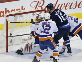 Winnipeg Jets' Shawn Matthias scores on New York Islanders goalie Jaroslav Halak during Friday's game. (THE CANADIAN PRESS)