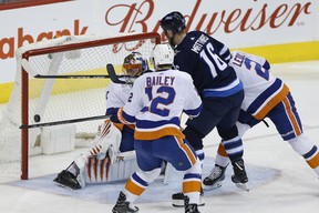 Winnipeg Jets' Shawn Matthias scores on New York Islanders goalie Jaroslav Halak during Friday's game. (THE CANADIAN PRESS)