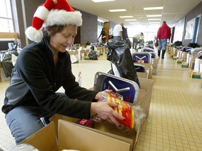Josie Hill of the Ma Mawi Wi Chi Itata Centre packs hampers for needy Aboriginal families at RB Russell High School in a 2007 file shot. Hill was one of five Manitobans named to the Order of Canada on Friday.