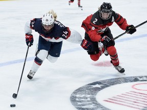 Dani Cameranesi (24) of the United States controls the puck against Meghan Agosta (2) of Canada during the second period Sunday in St Paul, Minn.