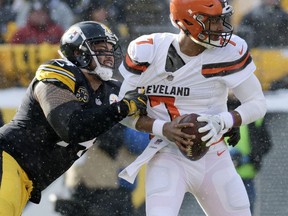 Cleveland Browns quarterback DeShone Kizer (7) is sacked by Pittsburgh Steelers defensive end Tyson Alualu (94) during the first half of an NFL football game in Pittsburgh, Sunday, Dec. 31, 2017.