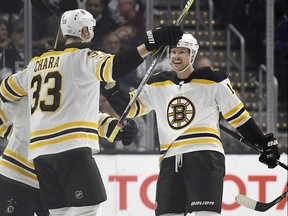 Boston Bruins defenseman Zdeno Chara, left, of Slovakia, celebrates his goal with defenseman Paul Postma during the second period of an NHL hockey game against the Los Angeles Kings, Thursday, Nov. 16, 2017, in Los Angeles. (AP Photo/Mark J. Terrill) ORG XMIT: LAS113
