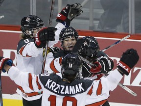Left to right: Canada’s Jennifer Wakefield, Jillian Saulnier, Halli Krzyzaniak and Jocelyne Larocque celebrate Saulnier’s goal. (The Canadian Press)