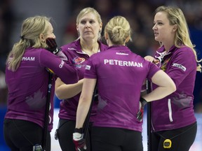Skip Chelsea Carey (right) speaks with teammates third Cathy Overton-Clapham (left), lead Laine Peters and second Jocelyn Peterman during the Olympic curling trials in Ottawa on Dec. 6, 2017.