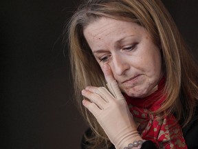 Lawyer Maria Mitousis, who was injured in an office bombing on July 3, hesitates while speaking about her co-workers to media during a press conference in Winnipeg, Wednesday, September 30, 2015. A man accused of sending letter bombs to his ex-wife and two Winnipeg law offices says he did not send the packages and has no experience with explosives.Guido Amsel is testifying at his trial where he faces five counts of attempted murder and several explosives-related charges.THE CANADIAN PRESS/John Woods