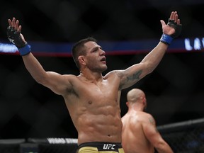 Rafael Dos Anjos celebrates his win over Robbie Lawler in the main event at UFC Fight Night-Lawler vs Dos Anjos in Winnipeg on Saturday night. (THE CANADIAN PRESS)