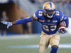 Winnipeg Blue Bombers' TJ Heath (23) runs the ball after an interception against the Calgary Stampeders during the first half of CFL action in Winnipeg Friday, July 7, 2017.