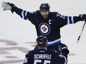 Winnipeg Jets' Blake Wheeler (26) and Mark Scheifele (55) celebrate Scheifele's game winning goal against the Carolina Hurricanes during overtime NHL action in Winnipeg on Thursday, October 13, 2016. THE CANADIAN PRESS/John Woods ORG XMIT: JGW117 ORG XMIT: POS1610132205373234 ORG XMIT: POS1610162213010980 ORG XMIT: POS1711202019433327