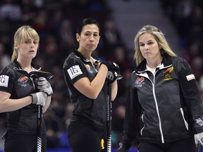 Skip Jennifer Jones of Winnipeg, Man. heads down the sheet to throw her last stone as lead Dawn McEwen and second Jill Officer look on during the tenth end of the women's semifinal against Team Homan at the 2017 Roar of the Rings Canadian Olympic Trials in Ottawa on Saturday, Dec. 9, 2017. THE CANADIAN PRESS/Justin Tang