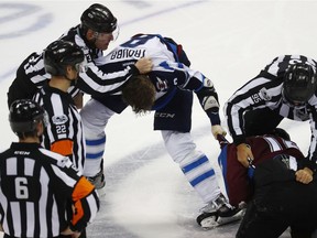 Linesman Vaughan Rody (far left) pulls Winnipeg Jets defenceman Jacob Trouba off Colorado Avalanche defenceman Nikita Zadorov. Rody will be honored at Monday's Jets game.