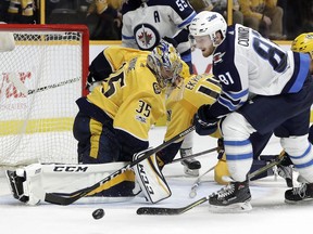 Nashville Predators goalie Pekka Rinne (35) blocks a shot by Winnipeg Jets left wing Kyle Connor (81) during an NHL hockey game, Monday, Nov. 20, in Nashville, Tenn. The Predators won 5-3.