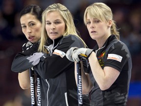 Team Jones skip Jennifer Jones, centre, stands with second Jill Officer and lead Dawn McEwen, right, during the Canadian Olympic trials in Ottawa on Sunday, December 3, 2017.