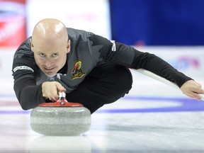 Team Koe lead skip Kevin Koe, from Calgary, Alta., throws a stone during fourth end Roar of the Rings Olympic Curling Trials action against the Team McEwen in Ottawa on Sunday, December 10, 2017. THE CANADIAN PRESS/Adrian Wyld