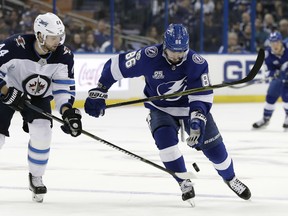 Tampa Bay’s Nikita Kucherov (right) notched the tying goal against the Jets on Saturday night. (The Associated Press)