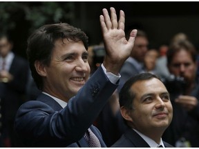 Prime Minister Justin Trudeau, accompanied by Mexican Senate President Ernesto Cordero, right, waves upon his arrival to the Mexican Senate, in Mexico City, Friday, Oct. 13, 2017. (AP Photo/Marco Ugarte)