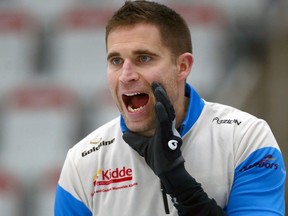 John Morris yells as he goes up against Brad Jacobs' team during the Champions Cup curling at Winsport in Calgary on April 26, 2017