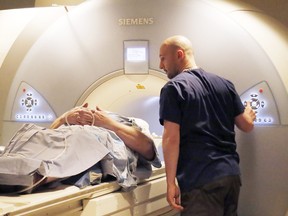 A technologist prepares to scan a patient with the MRI machine.
Postmedia Network Files