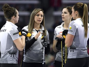 Skip Rachel Homan, second from left, talks with second Joanne Courtney, left, lead Lisa Weagle, and third Emma Miskew between ends during the women's semifinal draw against Team Jones at the 2017 Roar of the Rings Canadian Olympic Trials in Ottawa on Saturday, Dec. 9, 2017.