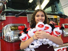 Sara Tabac, 13, with the help of the Firefighters' Burn Fund and Red River Mutual, donated 1,000 stuffed animals to the Winnipeg Fire Paramedic Service at No. 11 Station at 1705 Portage Avenue on Monday, Dec. 18. 
Scott Billeck/Winnipeg Sun