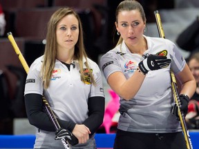 Rachel Homan, left, of Ottawa, and Emma Miskew speak as they watch a shot approach the house during the Canadian Olympic curling trials on Dec. 3, 2017