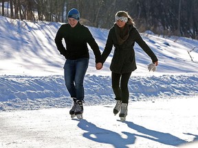 Skaters on the Red River Mutual Trail along the Assiniboine River at The Forks.