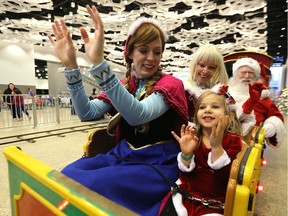 Rowan Dueck, 2, rides the train with Princess Anna and Mr. and Mrs. Santa Claus during the Holiday Carnival for Kidz at the RBC Convention Centre in Winnipeg on Sunday afternoon.
