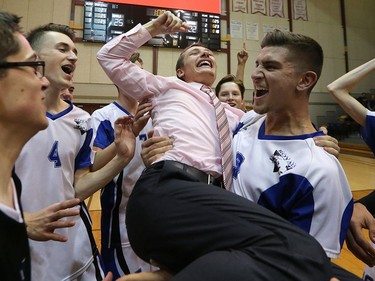 YEAR IN REVIEW: Assistant coach Michael Singleton is hoisted by Nigel Nielsen after the Lord Selkirk Royals defeated the River East Kodiaks in the AAAA provincial high school volleyball championship game at Investors Group Athletic Centre in Winnipeg on Mon., Dec. 4, 2017. Kevin King/Winnipeg Sun/Postmedia Network ORG XMIT: POS1712042244264382