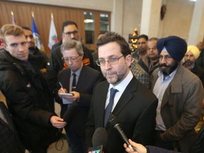 Scott McFadyen, spokesman for the Winnipeg Community Taxi Coalition, talks to members of the media at City Hall, in Winnipeg today.  Ride sharing services were being discussed.   Wednesday, December 06, 2017.   Sun/Postmedia Network