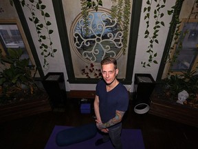 Peg City Yoga owner/instructor Noah Krol poses in his studio on Osborne Street in Winnipeg on Thurs., Dec. 7, 2017. Peg City will host a yoga marathon on Saturday, with all proceeds going to Mount Carmel Clinic's Mothering Project. Kevin King/Winnipeg Sun/Postmedia Network