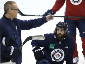 Mathieu Perreault listens to head coach Paul Maurice during Winnipeg Jets practice at Bell MTS Centre on Wednesday.