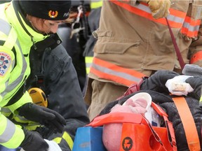 Injured man is tended to by paramedics following a December 2017 rollover car accident. St. Mary's Road between St. Anne's Road and Mager Drive now has the honourary designation of 'Paramedic Way' after an announcement on Monday.
