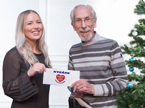 Nygard special events coordinator Heather Durward (left) presents a cheque to Kai Madsen, executive director of the Christmas Cheer Board.