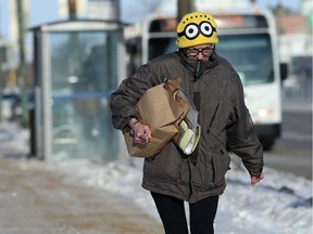 A woman walks along Main Street near Jarvis Avenue in Winnipeg on Sunday.