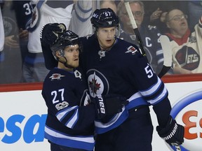 Winnipeg Jets forward Nikolaj Ehlers (left) celebrates his goal against the Chicago Blackhawks in Winnipeg with defenceman Tyler Myers on Thurs., Dec. 14, 2017. Kevin King/Winnipeg Sun/Postmedia Network