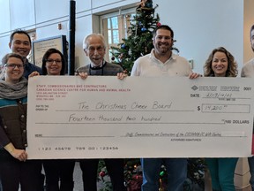 Tracy Drew (from left), Allan Lau, Helene Taylor, Kai Madsen, Lev Learney, Tamara Kruk, Ravinder Singh Lidder with the cheque for $14,200 from the Canadian Science Centre for Human and Animal Health.