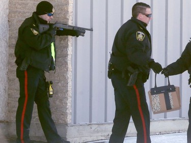 Police surrounded an address on Pritchard Avenue, in Winnipeg's North End, and ordered the occupants out.  Officers directed firearms at the individuals who exited.   Wednesday, February 8, 2017.   Sun/Postmedia Network