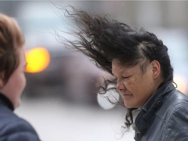 A winter storm has hot much of southern Manitoba, Winnipeg was spared heavy snow, but did get strong wind.   This woman was walking along Portage Avenue, downtown.  Tuesday,  March 05, 2017.   Sun/Postmedia Network