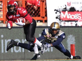 CALGARY.;  July 18, 2015 -- Calgary Stampeders Tim Brown, left, evades Winnipeg Blue Bombers Brendan Morgan during their game at McMahon Stadium on July 18, 2015. Photo Leah Hennel/Calgary Herald (For Sports story by Rita Mingo)