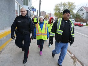Members of the Bear Clan Patrol including executive director James Favel (right) patrol the North End. On Saturday, the Bear CVlan patrol will hold their first family fun day in the field between Niji Mahkwa School and Children of the Earth High School.