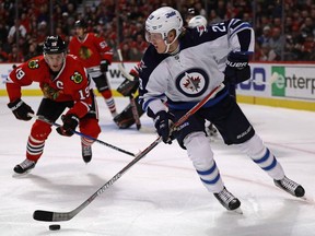 Blackhawks captain Jonathan Toews (19) isn't surprised by the play this season of Patrik Laine (29) and the Winnipeg Jets.