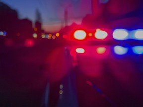 Red and blue Lights of police car in night time. Night patrolling the city. Abstract blurry image.