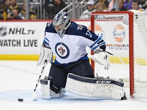 Connor Hellebuyck has been a big reason why the Winnipeg Jets are atop of the Central Division standings at the midway point of the 2017-18 season. (Photo by Justin Berl/Getty Images)