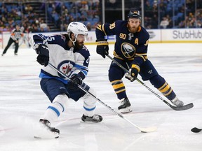 BUFFALO, NY - JANUARY 9: Mathieu Perreault #85 of the Winnipeg Jets skates with the puck as Ryan O'Reilly #90 of the Buffalo Sabres defends in the third period at the KeyBank Center on January 9, 2018 in Buffalo, New York. The Jets beat the Sabres 7-4. (Photo by Kevin Hoffman/Getty Images)