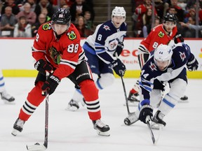 Blackhawks star Patrick Kane readies to shoot against defenceman Josh Morrissey during last night’s 2-1 Jets loss at Chicago. Getty Images