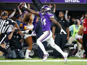 Stefon Diggs of the Minnesota Vikings scores a touchdown as time expires against the New Orleans Saints during the second half of the NFC Divisional Playoff game at U.S. Bank Stadium on January 14, 2018 in Minneapolis, Minnesota.