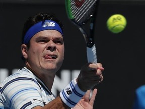 Canada's Milos Raonic makes a forehand return to Slovakia's Lukas Lacko during their first round match at the Australian Open tennis championships in Melbourne, Australia, Tuesday, Jan. 16, 2018.