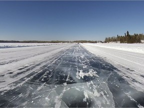 A winter road crosses a lake.
