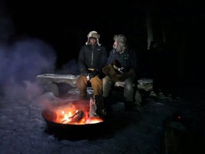 Robert Thiessen, right, and his brother-in-law Joe Kaonga perform the parody video of Toto's 'Africa' about Manitoba's winter in Oak Lake, Man., in a December 2017 still image made from video footage.