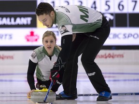 .Jocelyn Peterman delivers her stone as playing partner Brett Gallant brushes her stone during the first round of playoffs. (Michael Burns photo)
